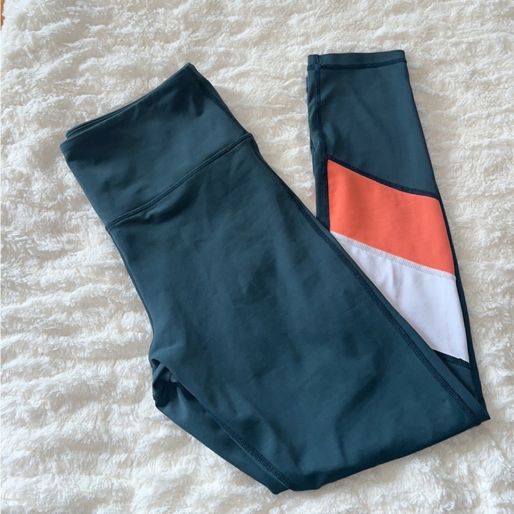 ZYIA teal leggings with coral and white stripes.